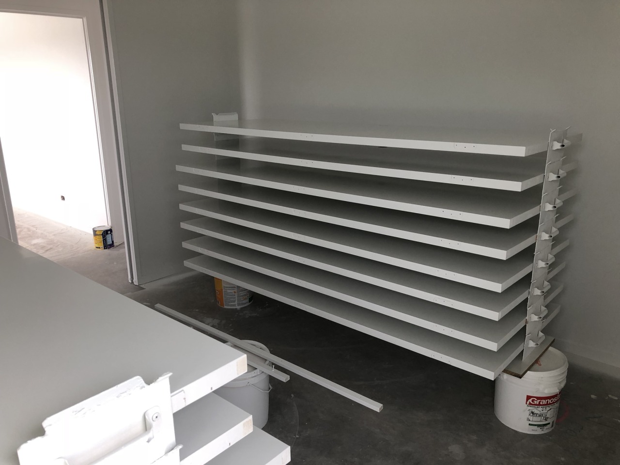 Freshly painted doors drying horizontally on stackers